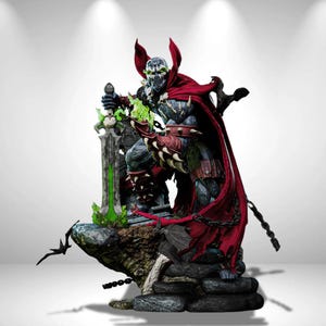 May include: A detailed Spawn action figure featuring a dark textured suit, a long flowing red cape, and spiked gauntlets. The character holds a large sword with a glowing green blade and stands on a rocky base with chains and bat-like creatures.