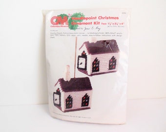 May include: Needlepoint Christmas Ornament Kit featuring two 1 1/2" x 3" x 4" Country Church designs. The kit includes plastic canvas, acrylic yarn, a needle, and instructions.