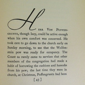 May include: A black and white image of a handwritten letter H with the text "ERR VON PUFFEN-GRUNTZ, though lazy, could be active enough when his own comfort was concerned. He took care to go down to the church early on Sunday morning, to see that the Wolfenstein pew was ready for occupancy. The Count so rarely came to services that other members of the congregation had made a habit of borrowing the cushions and hassocks from his pew; the last time they were in church, at Christmas, Puffengruntz had been [43]"