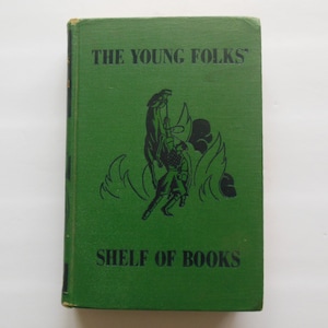 May include: A vintage hardcover book titled "THE YOUNG FOLKS' SHELF OF BOOKS" in dark green. The cover features a black illustration of a person on a horse. The book's spine is visible on the left side.
