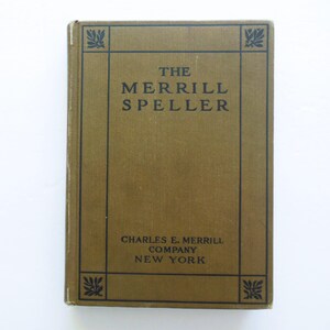 May include: A vintage copy of "The Merrill Speller" book. The cover is a muted olive green with black text and decorative corner designs. The title and publisher's information are clearly visible.