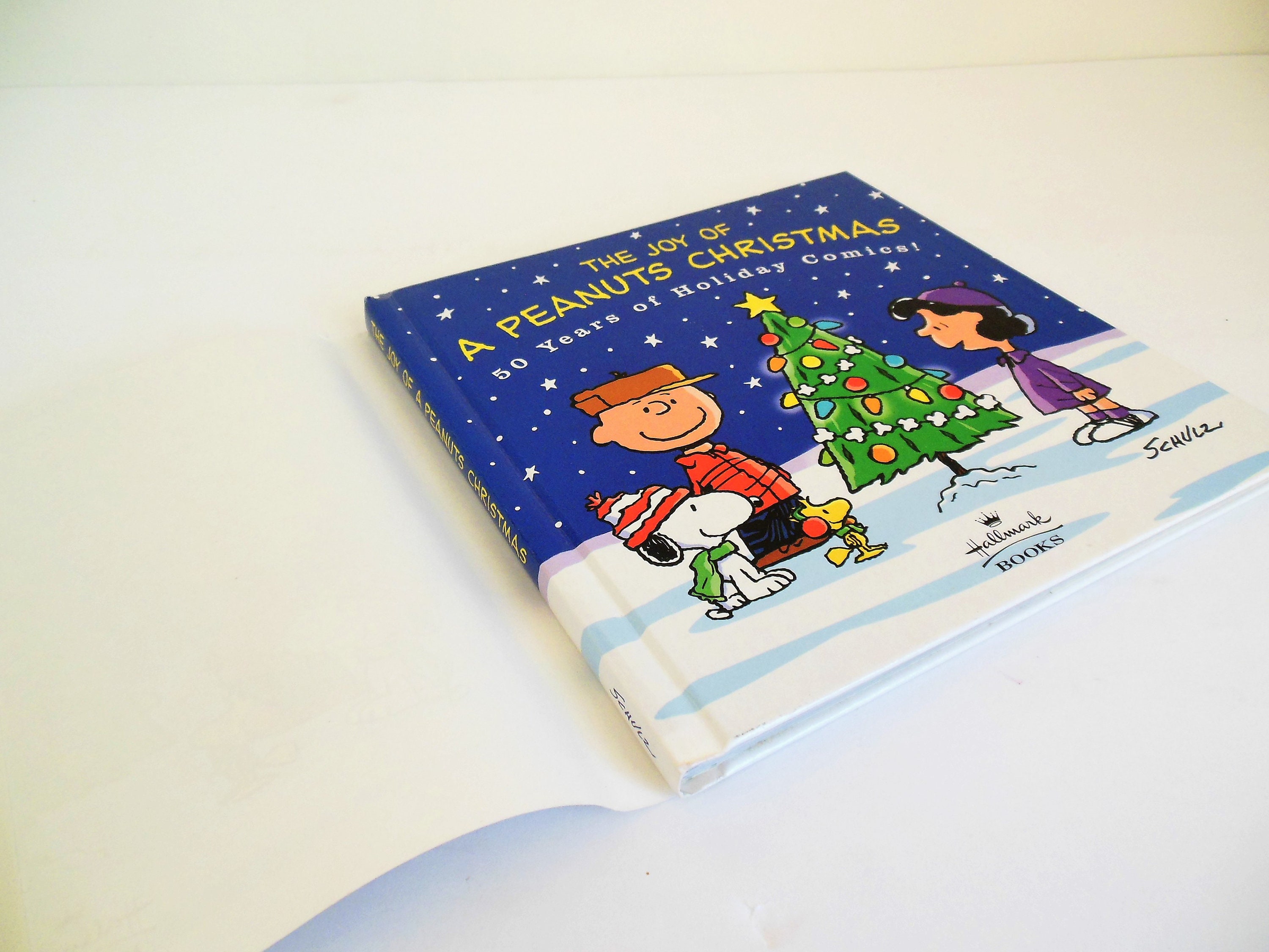 洋書 50years ofChristmasTables The Joy of a Peanuts Christmas 50 Years of Holiday Comics