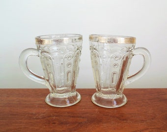 Jewel With Dewdrop Mugs, Two U S Glass Kansas State Series Antique Glasses, EAPG Little Handled Cups With Gold Trim, Sold As Is