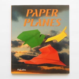 May include: A set of three ceramic mugs with a speckled, matte finish. The mugs are in shades of cream, light gray, and dark gray. Each mug has a simple, minimalist design and a rounded handle.