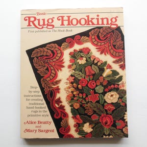 May include: A book titled "Basic Rug Hooking" with a floral rug design on the cover. The book is by Alice Beatty and Mary Sargent and was first published as "The Hook Book".