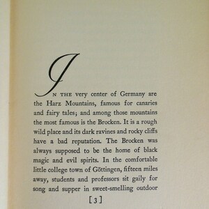 May include: A black and white image of a book page with text about the Harz Mountains in Germany. The text mentions the Brocken, a mountain known for its dark ravines and rocky cliffs. The text also mentions the nearby town of G&ouml;ttingen, where students and professors gather for song and supper.