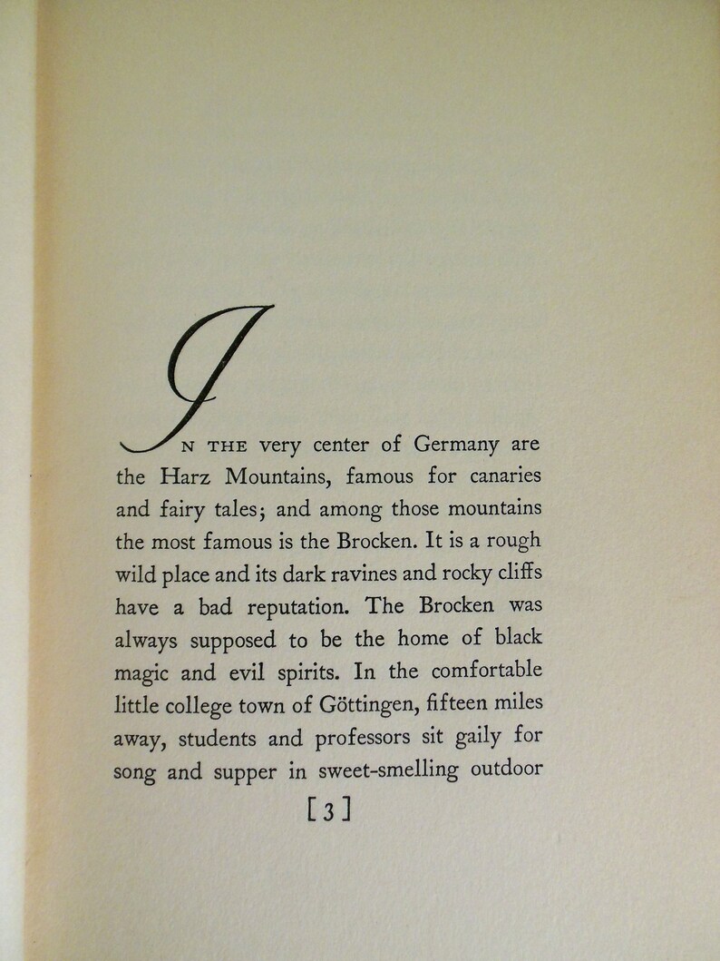 May include: A black and white image of a book page with text about the Harz Mountains in Germany. The text mentions the Brocken, a mountain known for its dark ravines and rocky cliffs. The text also mentions the nearby town of G&ouml;ttingen, where students and professors gather for song and supper.