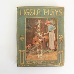 May include: A vintage book titled "Little Plays for Gold-Go-The Children" with a green cover and gold lettering. The cover features an illustration of two people in a kitchen setting.