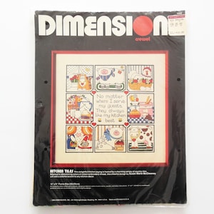May include: A cross-stitch pattern featuring a charming kitchen scene with a saying: "No matter where I serve my guests, They always like my kitchen best". The pattern is framed by a variety of country tiles with colorful animals and kitchen items. The pattern is 14 inches by 14 inches.