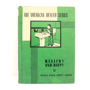 May include: A green book with the title "The American Health Series" and the subtitle "Healthy and Happy II" by Wilson-Baker-Abbott-Almack. The cover features a black and white illustration of a boy washing his hands at a sink.