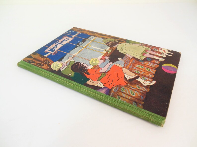 May include: A vintage children's book titled "Merry Times" with a green spine and a colorful illustration of children playing by a window on the cover.