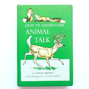 May include: A vintage hardcover book titled "How to Understand Animal Talk" with illustrations of a deer and foxes on a green background. The book is by Vinson Brown, with drawings by William D. Berry.