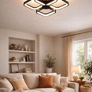 May include: Modern black and white ceiling light fixture with a geometric design. The light has four square-shaped panels with a bright white glow, creating a contemporary look. The fixture is mounted on a white ceiling.