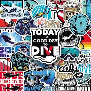May include: A collection of colorful scuba diving themed stickers. Designs include divers, diving masks, and phrases like "Today is a good day to dive" and "The ocean is calling." Various colors are used, including blue, red, and black.