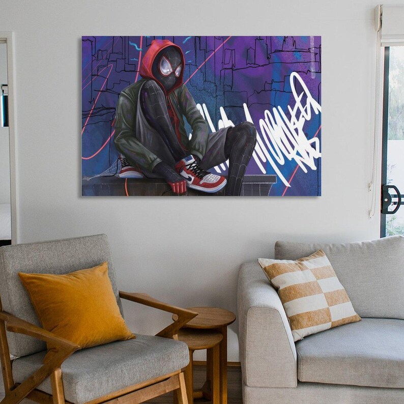 May include: A canvas print featuring a superhero in a black and red suit, seated against a graffiti-style background. The character wears a red hooded jacket and red, white, and black sneakers. The background is a mix of purple, blue, and white.