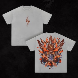 May include: Two light gray t-shirts. The front of one shirt has a brown and orange graphic. The back of the other shirt has a detailed graphic with a central figure, brown, orange, and blue elements.