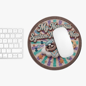 May include: A white ceramic mug with a black handle and the text "But First, Coffee" in a black, handwritten-style font. The mug is on a white surface.