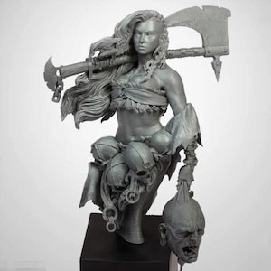 May include: A grey bust of a female warrior with long flowing hair, holding a large axe over her shoulder. She wears a fur-trimmed top and a skirt adorned with skulls. A severed head hangs from her arm.