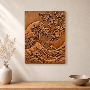 May include: A rectangular wooden wall art piece featuring a detailed relief carving of a large crashing wave, a mountain peak in the background, and a branch of cherry blossoms extending from the top right corner, all in a natural wood tone.