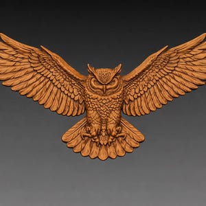 May include: A detailed wooden carving of an owl with outstretched wings. The owl is depicted in a frontal view, showcasing intricate feather details and a focused gaze. The carving is a warm brown color, set against a gray background.