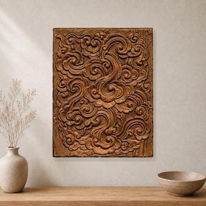 May include: A rectangular wooden wall panel featuring a deep relief carving of swirling cloud-like patterns. The natural brown wood grain is visible throughout the intricate, flowing design, which covers the entire surface of the vertical plaque.