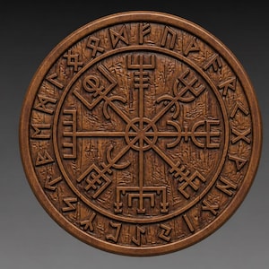 May include: A round, wooden carving featuring a detailed design of runes and a central compass-like symbol. The wood has a warm, brown tone, and the carving is set against a gray background. The design is likely inspired by Norse or Viking culture.