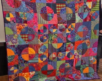 Kaffe Fassett drunkards path quilt.