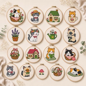 May include: A collection of seventeen circular wooden embroidery hoops featuring cross-stitch designs of cats, houses, flowers, and a mushroom. The cat designs include kittens in baskets, teacups, and wearing floral crowns, alongside floral arrangements.