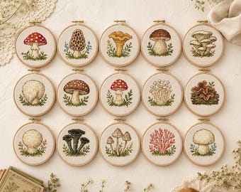 May include: Fifteen circular wooden embroidery hoops, each containing a unique cross-stitch design of a different mushroom species. The mushrooms are rendered in various colors including red, brown, yellow, and white, set against a light fabric.