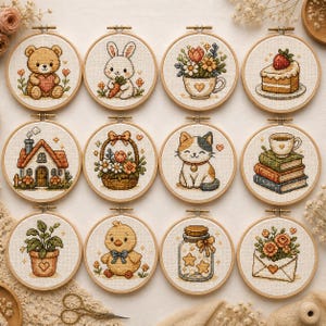 May include: Twelve circular cross-stitch embroidery hoops with diverse designs. These include a teddy bear, a rabbit with a carrot, flowers in a teacup, a cake slice, a house, a flower basket, a cat, a coffee cup on books, a potted plant, a chick, a jar of stars, and a floral envelope.