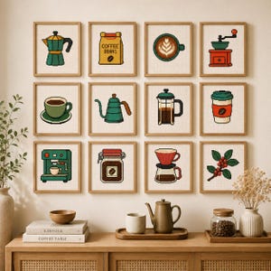 May include: A grid of twelve framed square cross-stitch artworks featuring coffee-themed pixel art designs, including a moka pot, coffee beans bag, latte art, grinder, cup, kettle, french press, to-go cup, espresso machine, jar, dripper, and berries.