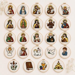 May include: A collection of twenty-four circular wooden embroidery hoops featuring pixel art cross-stitch designs of various religious figures, saints, angels, a lamb, a dove, a cross, a bible, a chalice, and a church on white fabric.