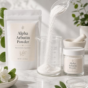 May include: A white pouch labeled Alpha Arbutin Powder Net Wt. 1 oz (28 g), a clear glass beaker with measurement markings, and a small glass jar of Alpha Arbutin Powder. A clear spoon pours white powder into the beaker, creating a fine stream.