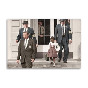 May include: A colour photograph shows a young Black girl in a dress and cardigan, escorted by men in suits and hats. The girl carries a handbag and walks down steps, flanked by men with armbands.