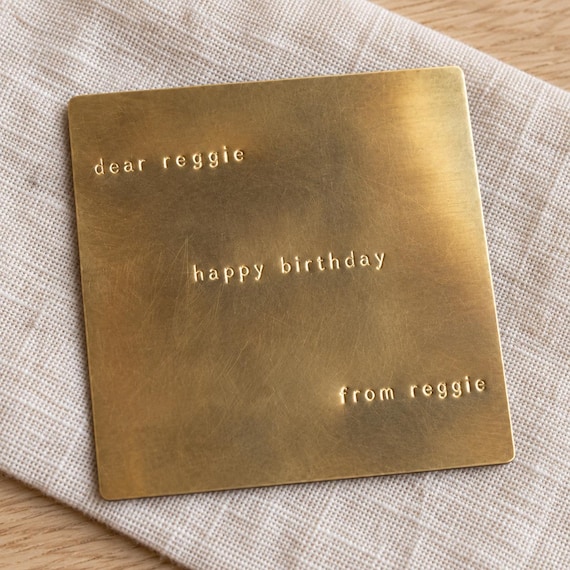A birthday card stamped into actual brass — it won't yellow, warp, or get thrown away, making it genuinely the most durable birthday card anyone has ever received.