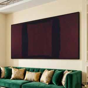 May include: Large abstract painting with a dark burgundy and black rectangular design, framed in black. The artwork hangs above a green velvet sofa with decorative pillows.