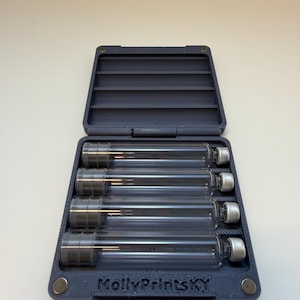 May include: A dark gray case with an open lid, containing five clear glass vials with silver and white caps. The case has the text "MollyPrintsKY" printed on the front.