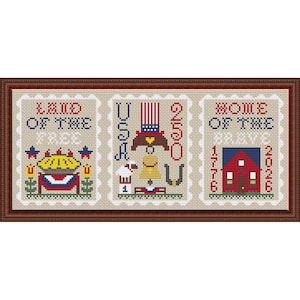 May include: Cross-stitch sampler in a brown frame. The sampler is divided into three sections, each resembling a postage stamp. The left section says "Land of the Free" and features a pie. The middle section says "USA" and features Uncle Sam. The right section says "Home of the Brave" and features a red house.