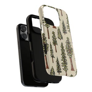 May include: A black smartphone with a protective case featuring a beige background and a repeating pattern of green and brown trees. The case is detached, showing the phone's camera and the inner black case.