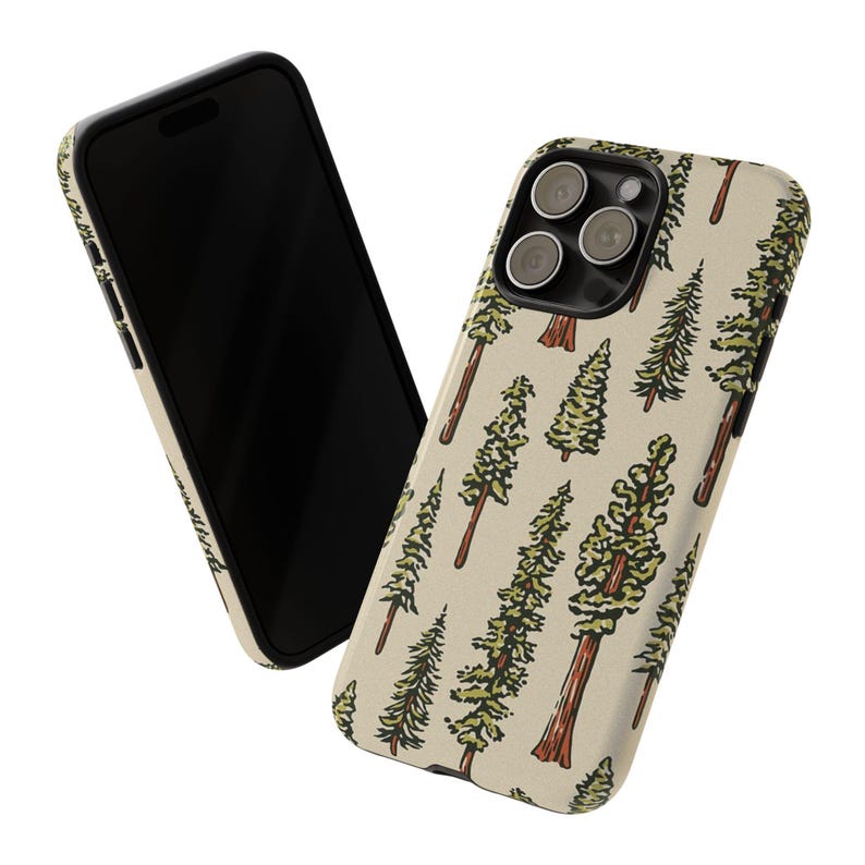 May include: A smartphone and a phone case with a nature-themed design. The case features a repeating pattern of green and brown trees on a beige background. The phone is black.