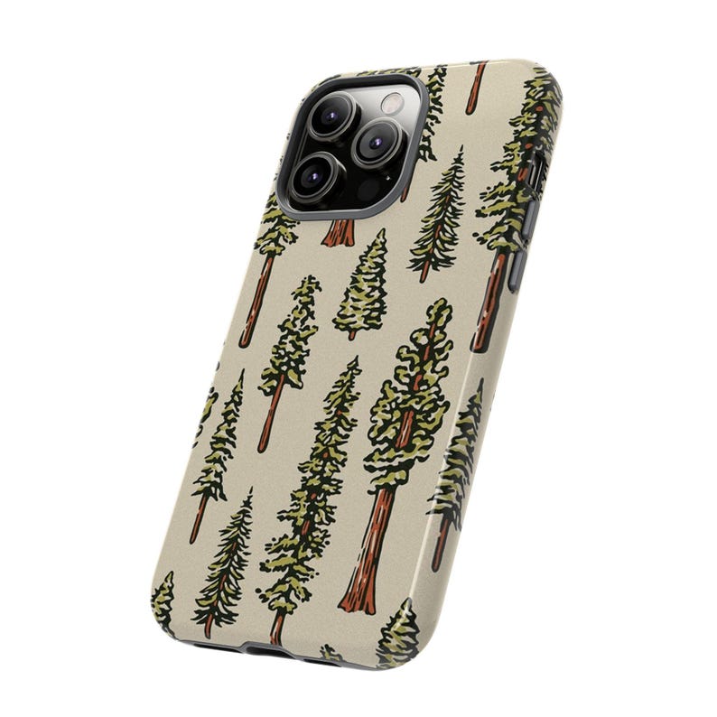 May include: A phone case with a beige background and a repeating pattern of stylized green and brown trees. The case has a camera cutout and a black border.