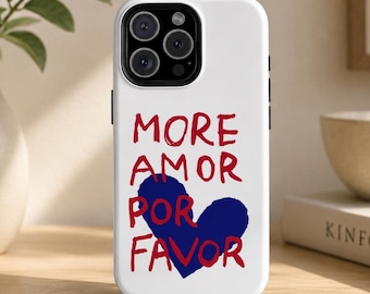 May include: White phone case with the words "MORE AMOR POR FAVOR" in red and a blue heart graphic. The phone case has a black camera module and black side buttons.