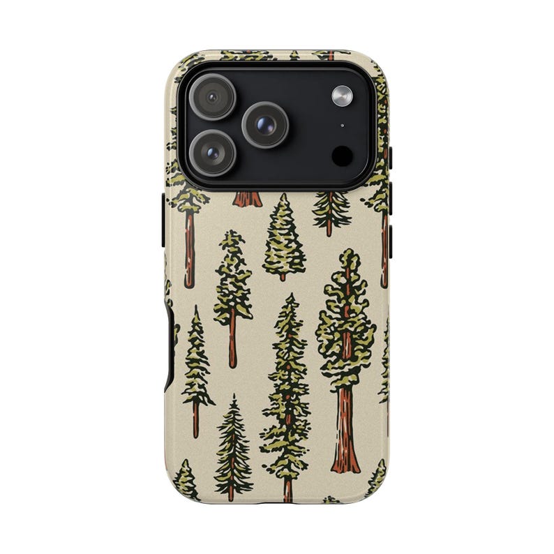 May include: A phone case featuring a repeating pattern of green and brown trees on a beige background. The case has a camera cutout with three lenses and a flash. The trees vary in size and style, with detailed green foliage and brown trunks.