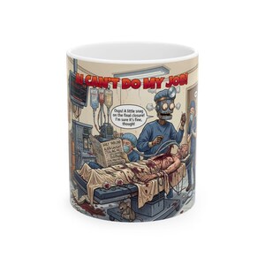 May include: White ceramic mug featuring a humorous cartoon scene of a robot surgeon in an operating room. The mug has the text "I CAN'T DO MY JOB!" and a newspaper headline "ALIEN CAUGHT STEALING PIES".