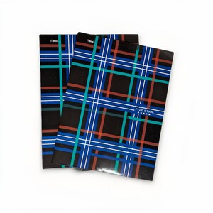 May include: Three Mead Five Star notebooks with a black background and a plaid pattern in blue, teal, red, and white. The notebooks are rectangular and have the Mead logo at the top and the Five Star logo at the bottom.