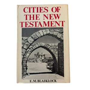 May include: A vintage book titled "Cities of the New Testament" with a cream-colored cover. The title is in red, with an image of stone arches and a pathway. The author's name, E.M. Blaiklock, is printed at the bottom.