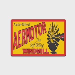 May include: Rectangular sign with a yellow background and a red border. The sign features the words "AERMOTOR" in large red letters, with "Auto-Oiled" above and "The Self Oiling WINDMILL" below. A black windmill graphic is on the right.