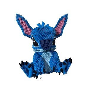 May include: A blue origami figure of a cartoon character with large ears and black eyes. The ears have pink interiors. The figure is sitting with its arms and legs outstretched. The figure is made of many small, folded pieces of paper.
