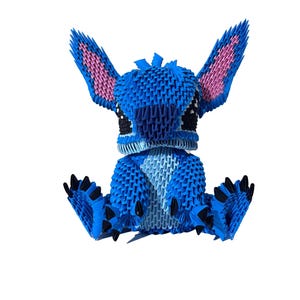 May include: A blue origami figure of a cartoon character with large ears and black eyes. The figure is sitting with its arms and legs outstretched. The ears have pink interiors, and the feet have black claws. The figure is made of many small, folded paper pieces.