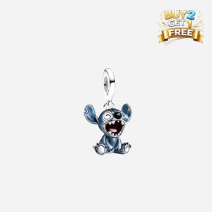 May include: A blue Stitch charm with a silver loop for a bracelet or necklace. The charm features Stitch with his mouth open and a happy expression. The charm has a metallic finish and is a Disney-themed product.